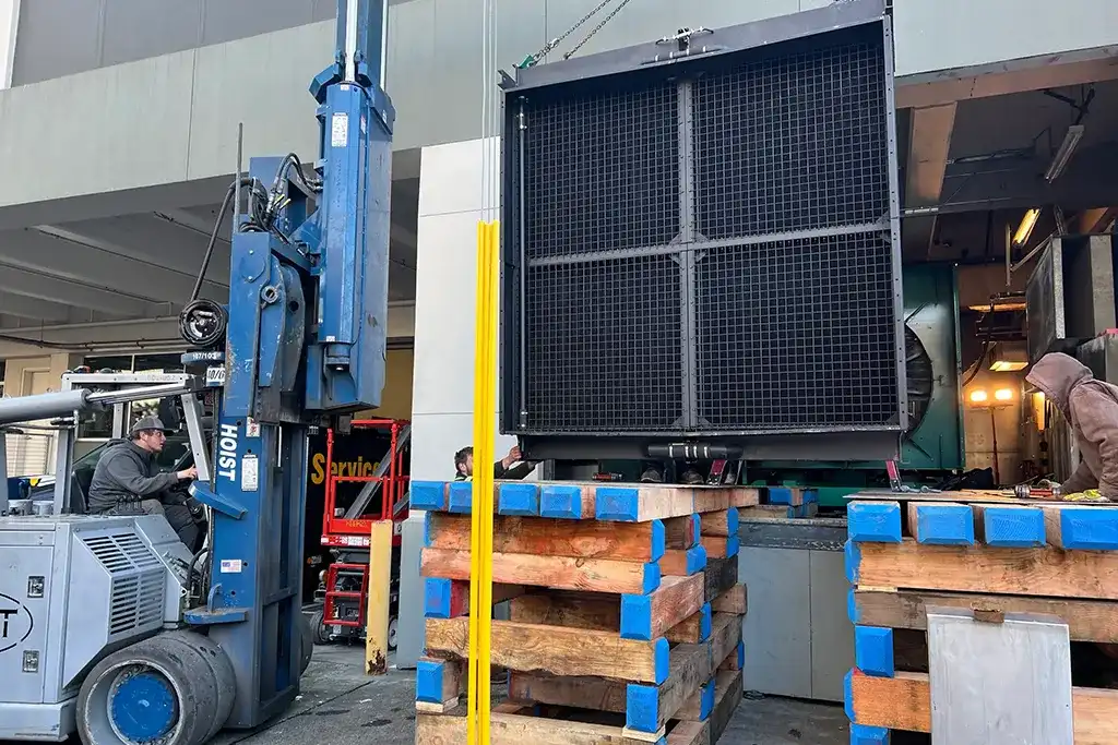 Precision rigging and heavy machinery moving using a Hoist forklift and specialized cribbing for industrial equipment.
