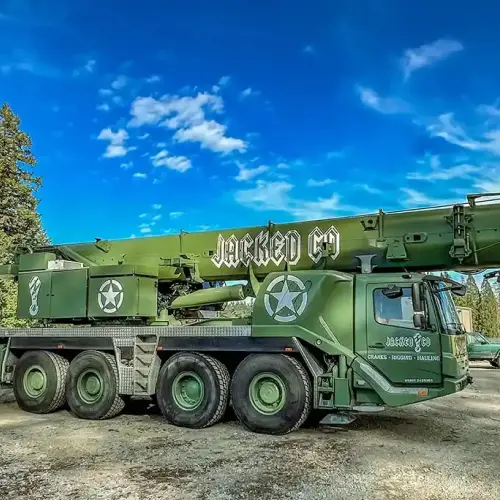 A Jacked Co. olive drab mobile crane with military-style branding and high-capacity boom